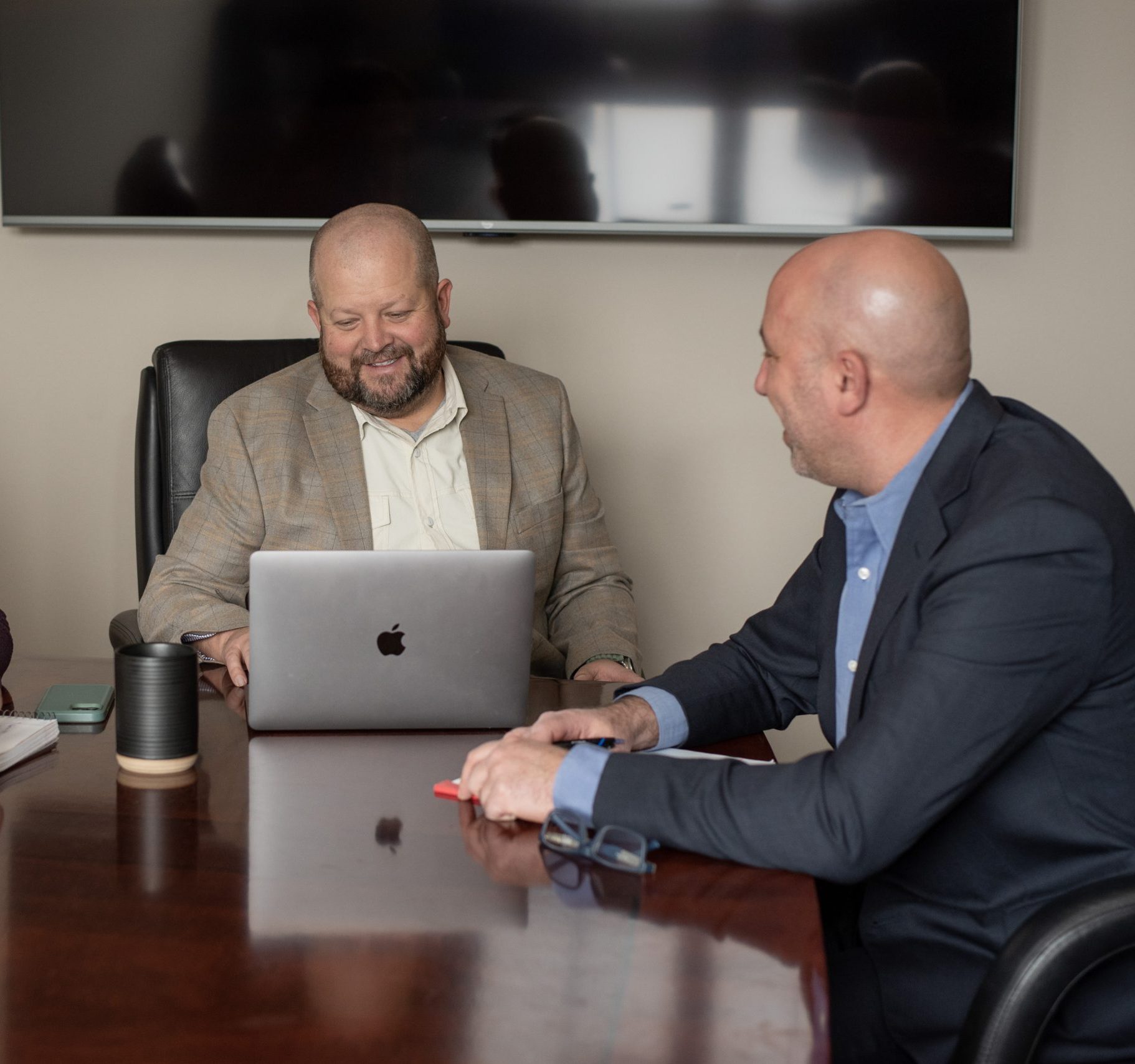 Two people talking across a desk
