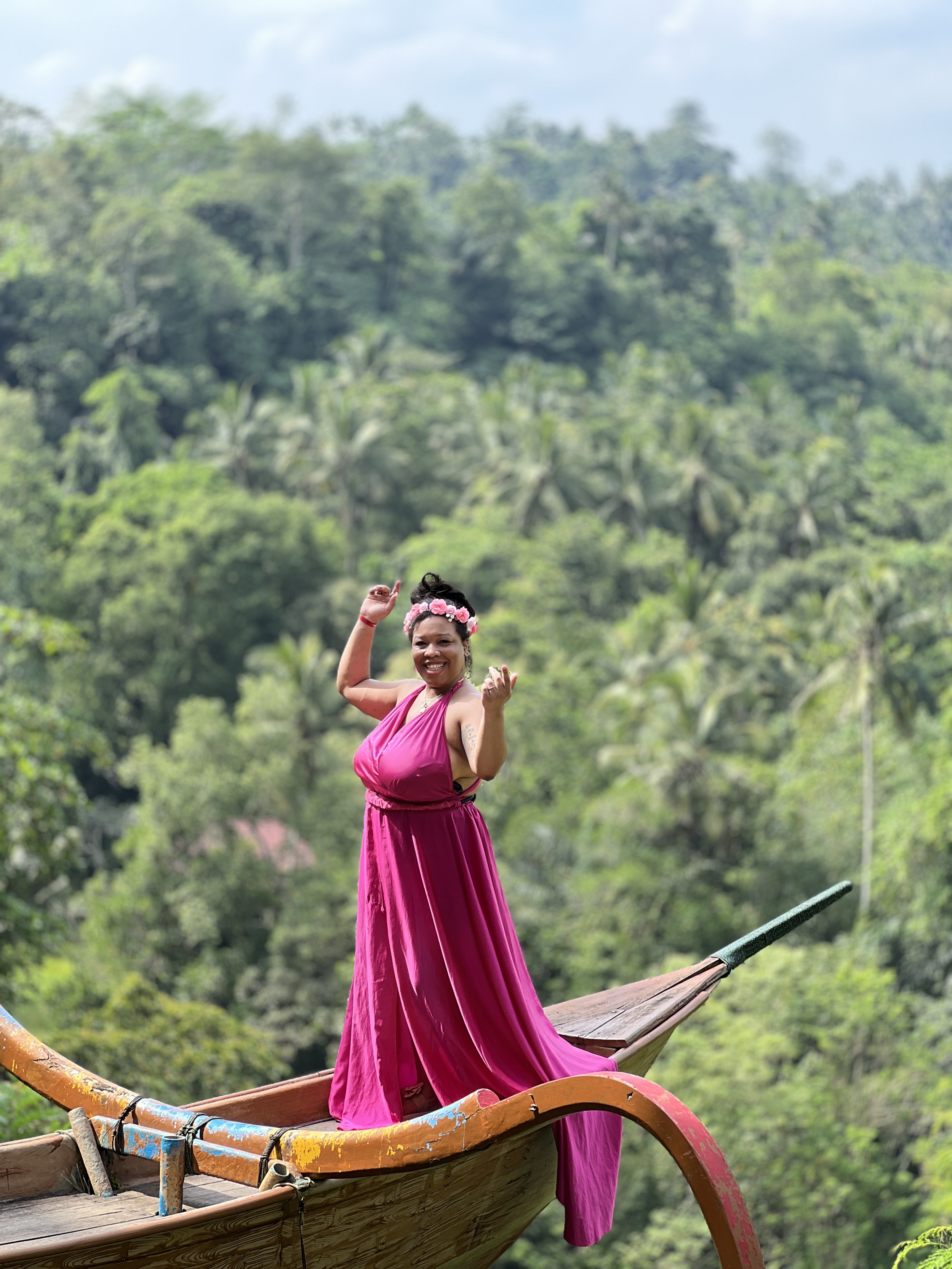Woman in pink dress on a boat in Bali