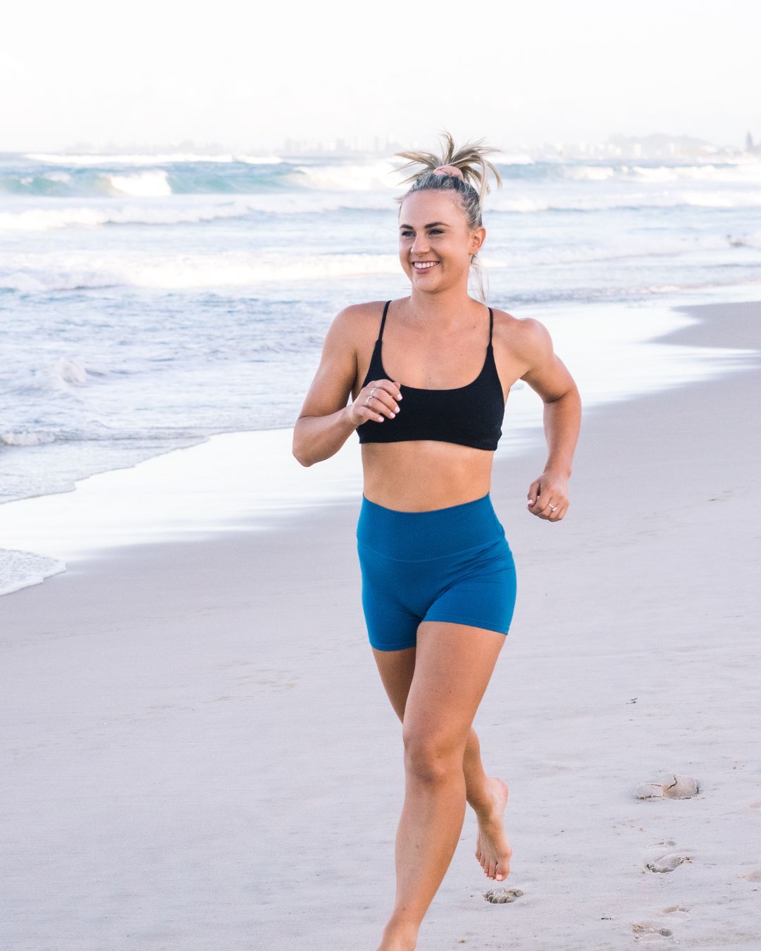 Holly running on the beach