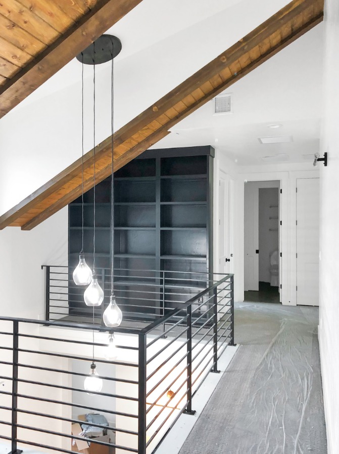 Custom dark built-in shelving in hallway