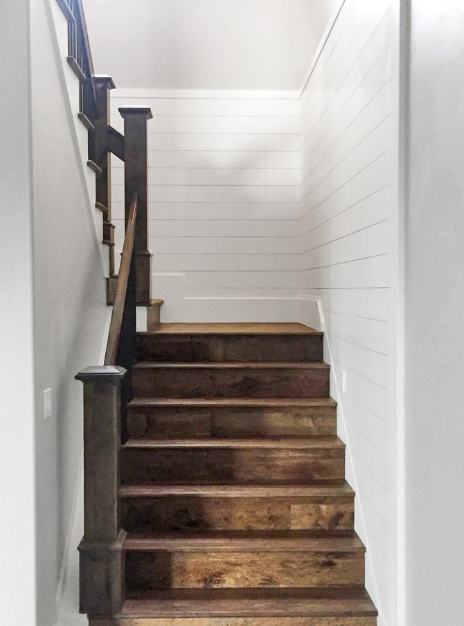 Custom wooden staircase with shiplap wall paneling