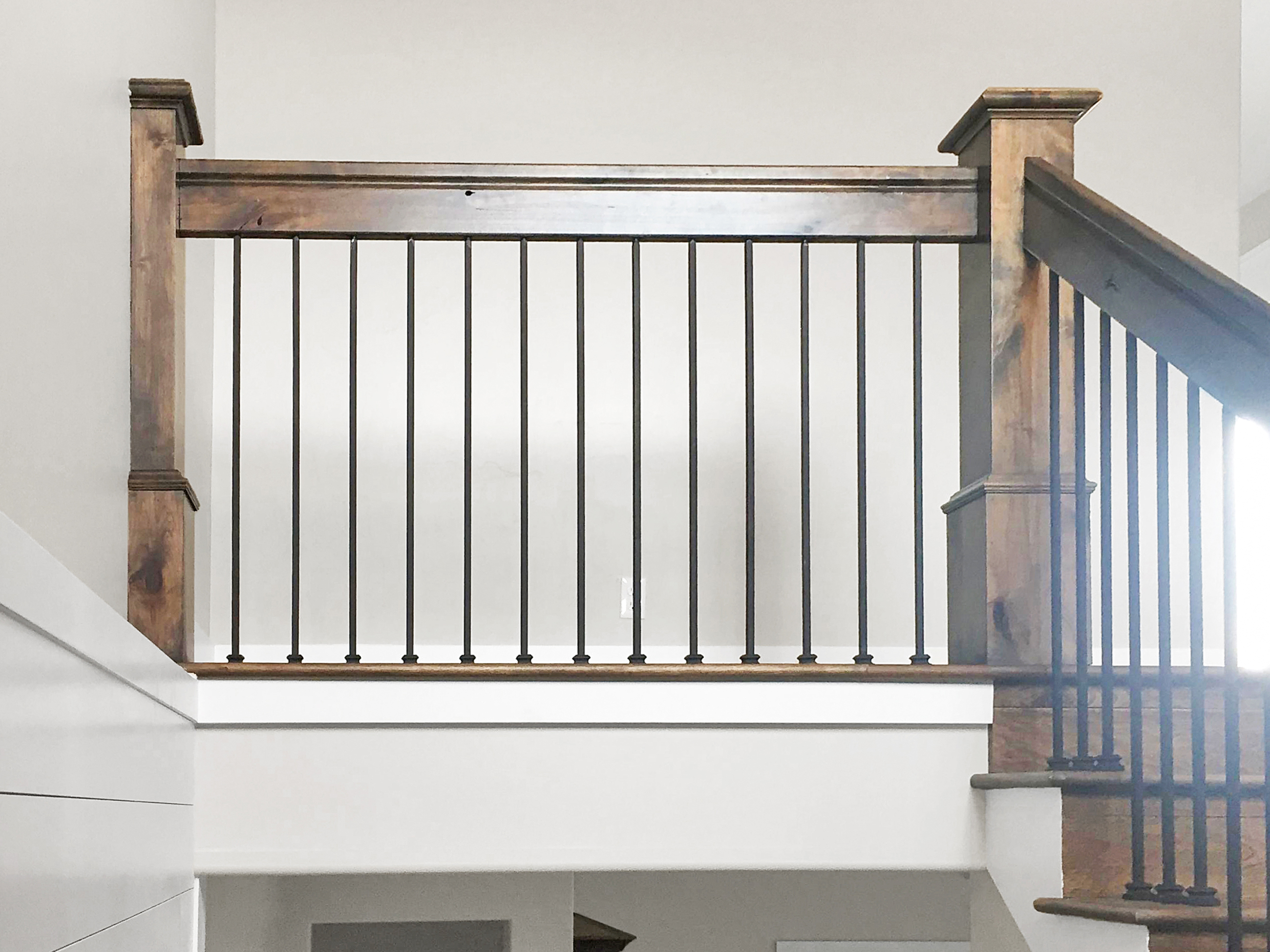 Craftsman wood railing and wrought iron balusters on upper landing