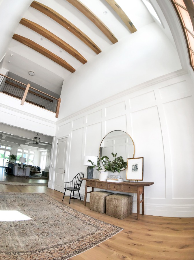 High ceiling room with custom wood beams and wall paneling in Utah County
