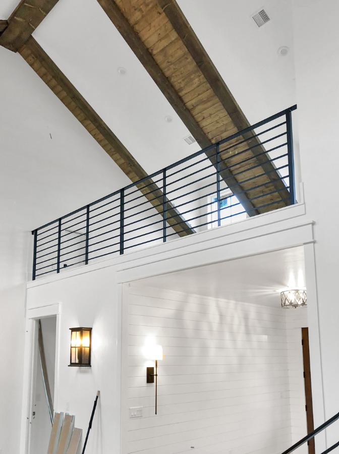 Custom metal railing installation in high ceiling living space