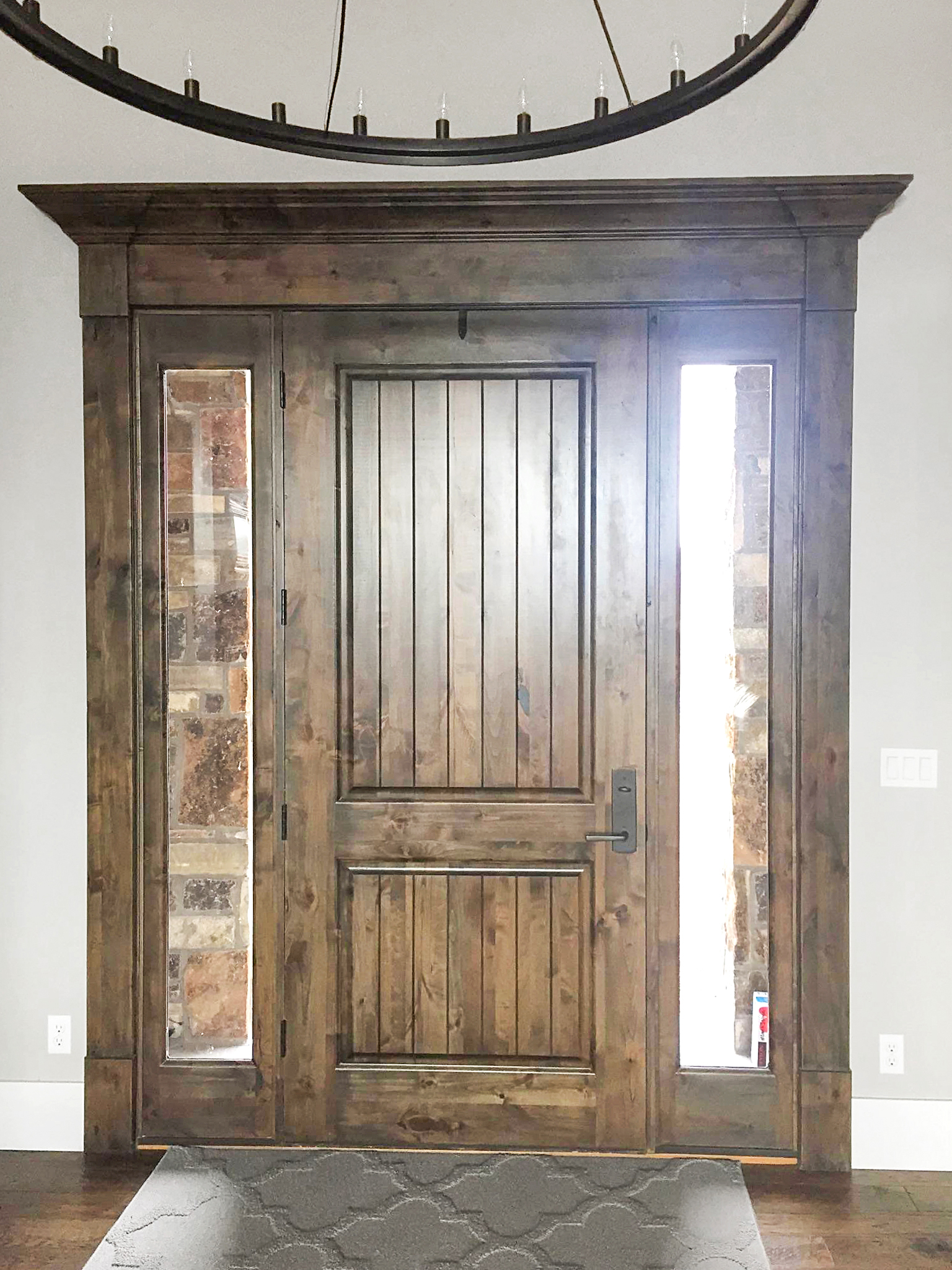 Custom wood front entry door with sidelights and craftsman casing trim