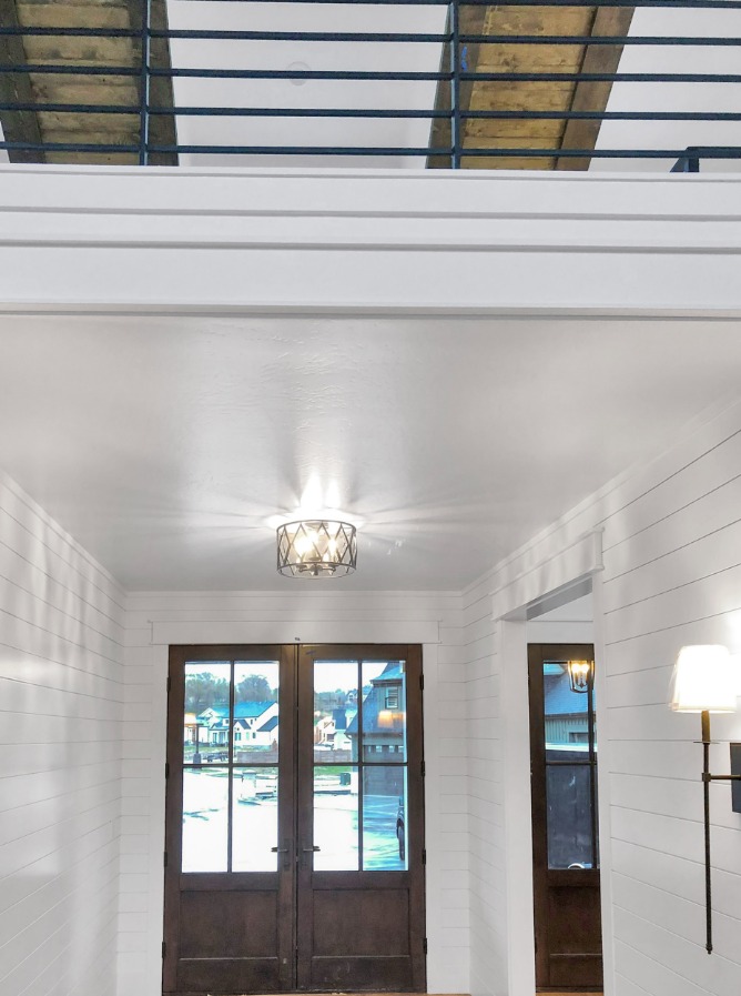 Entryway with shiplap walls and custom double doors in Springville, UT