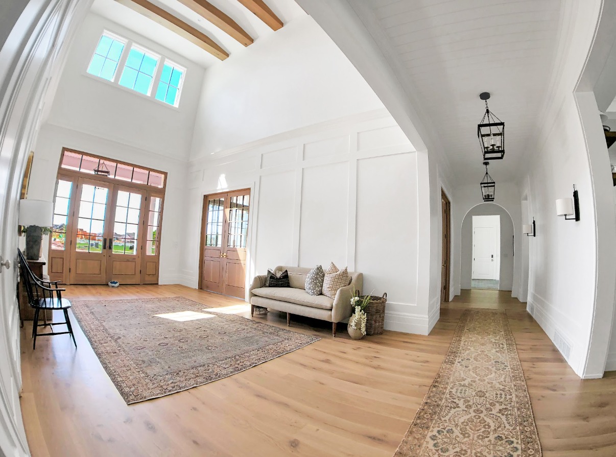 Large open living space with custom wall paneling and wood beams in Springville, UT