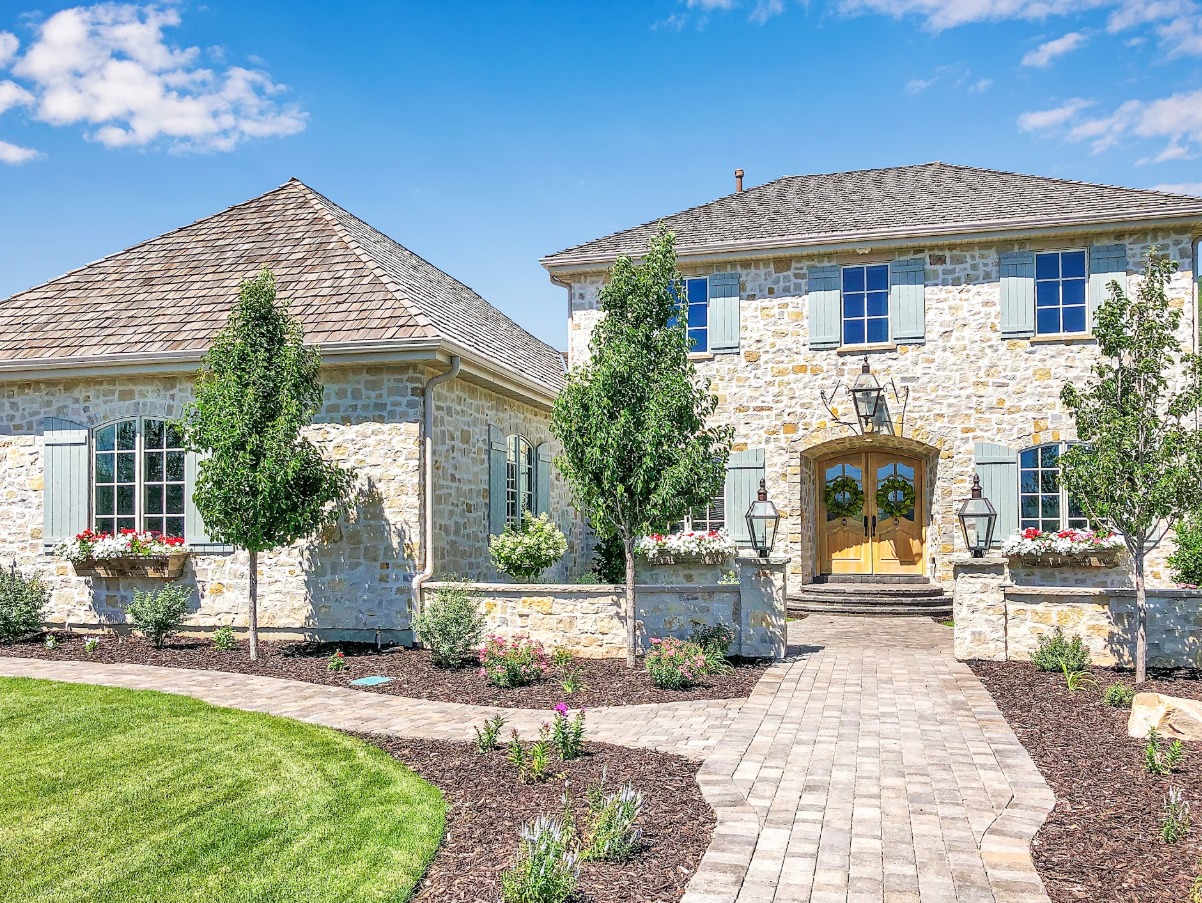 Exterior stone house with custom wood doors and trim