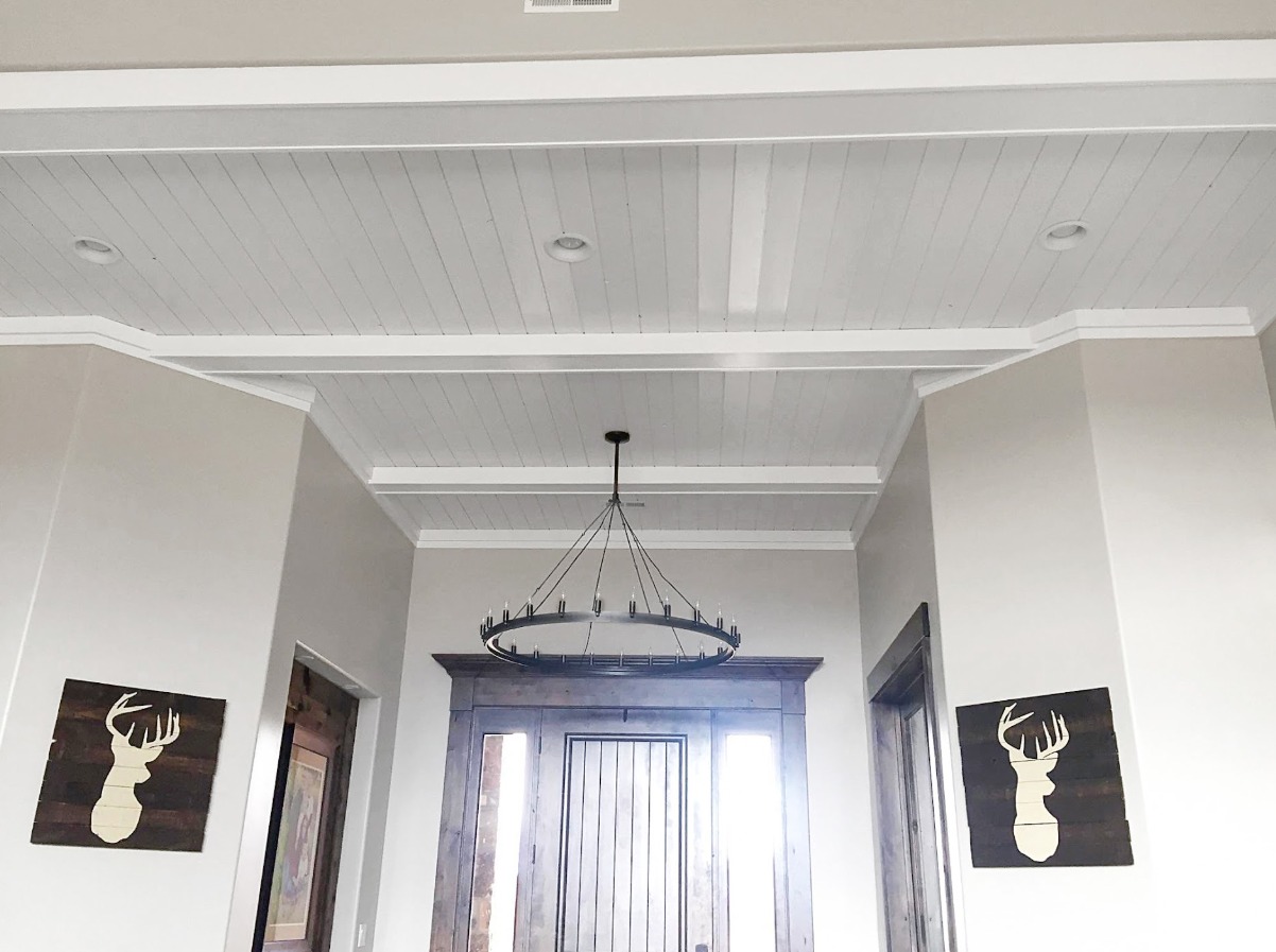 Custom hallway ceiling with wood paneling and trim