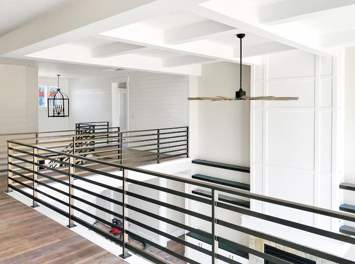 Modern metal staircase railing and custom wall paneling
