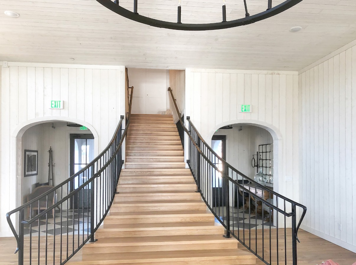 Custom staircase with wooden steps and metal railing by Sharp Blade Trim Works