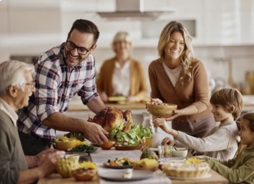 Multigenerational family enjoying a meal together in their kitchen.