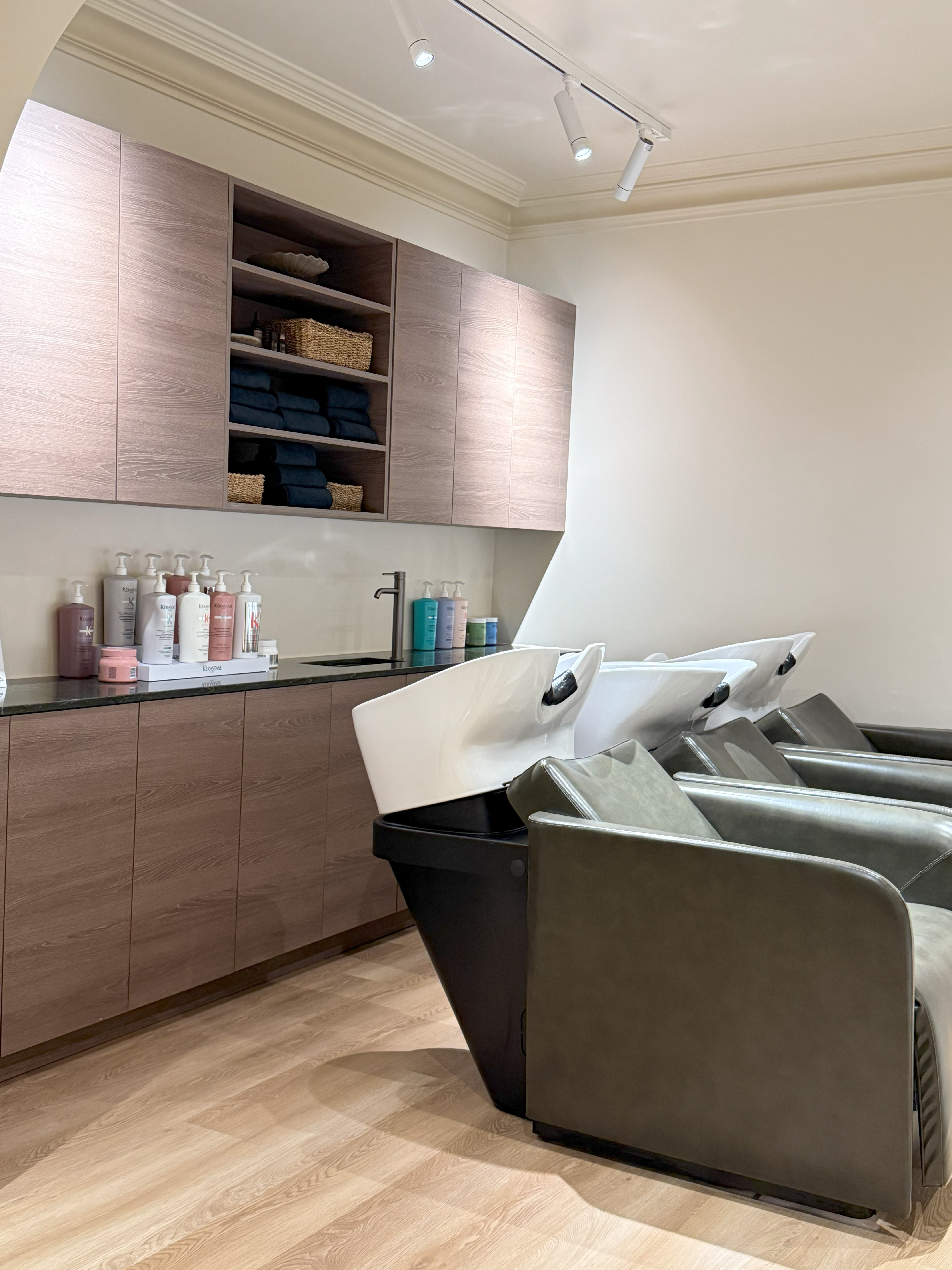 Luxury hair salon washing area with modern cabinetry and premium products - Crystal Clean result