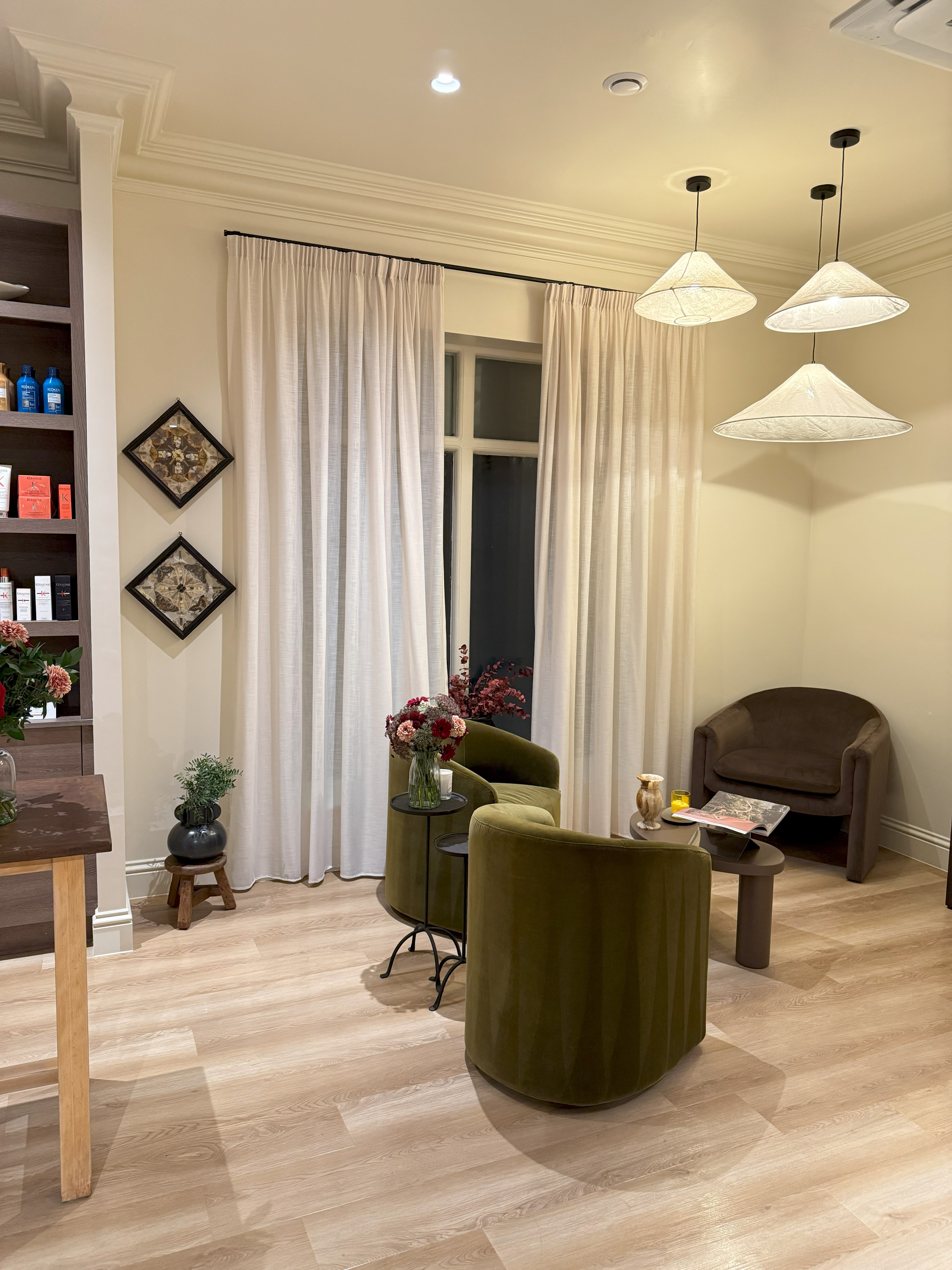 Elegant lounge area with green velvet chairs and pendant lighting - Crystal Clean commercial service