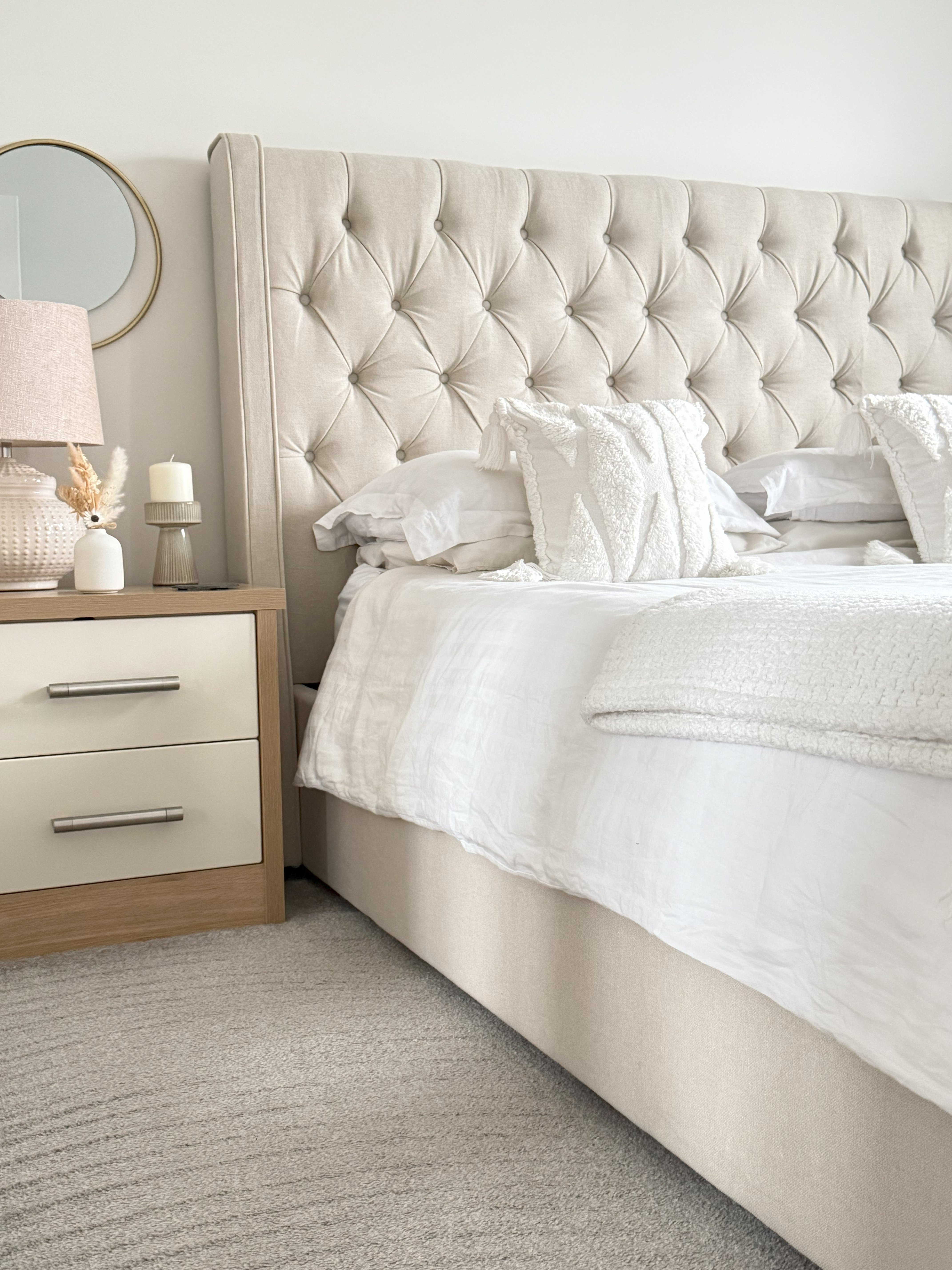 Pristine bedroom cleaned by Crystal Clean - featuring tufted headboard and fresh white bedding
