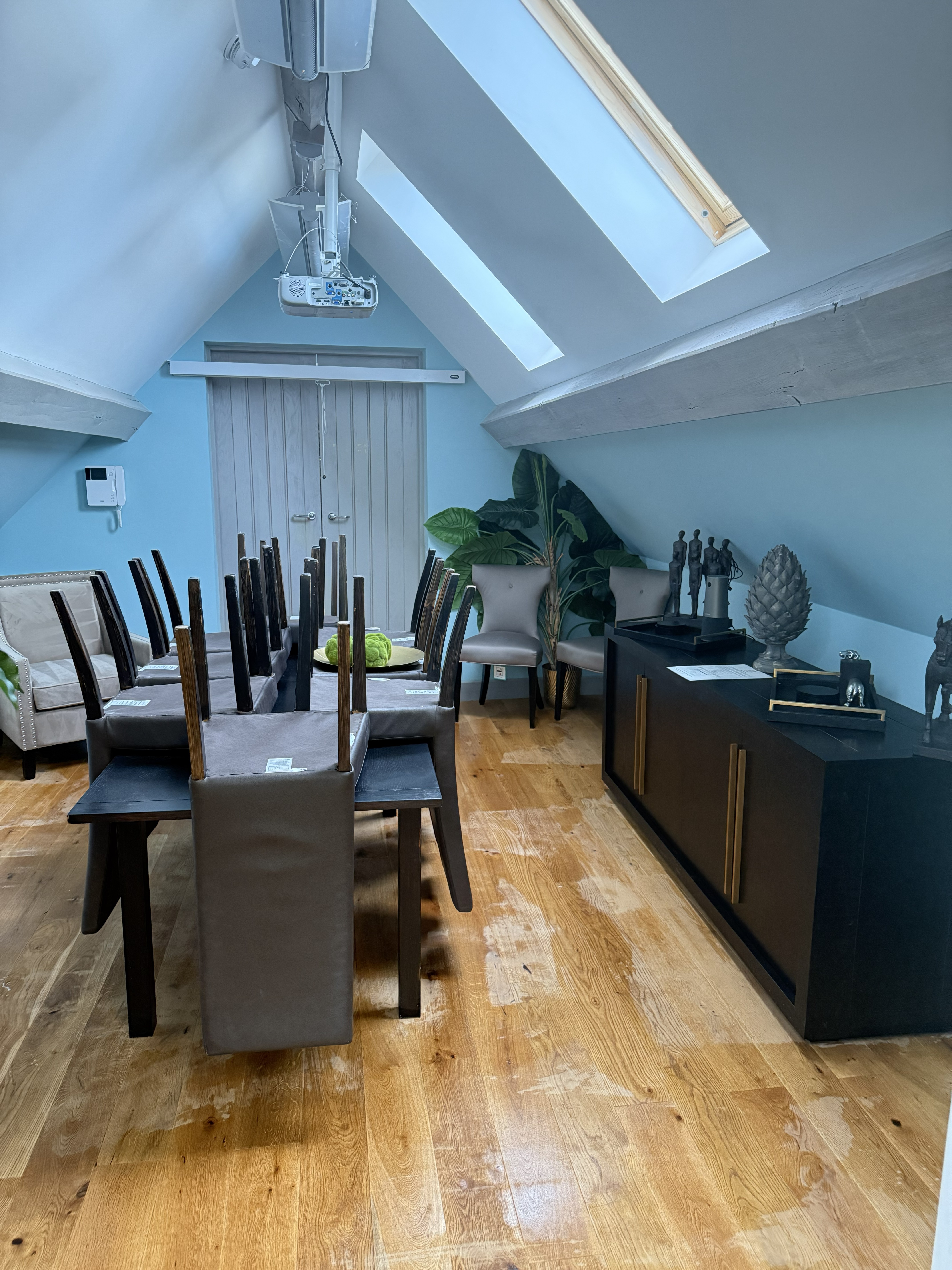 Modern office space with blue walls and wooden floors cleaned by Crystal Clean - showing dining area and kitchen