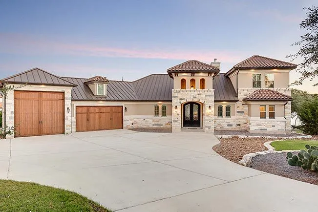 Front exterior of a custom-built luxury home in Canyon Lake showcasing modern Hill Country architecture