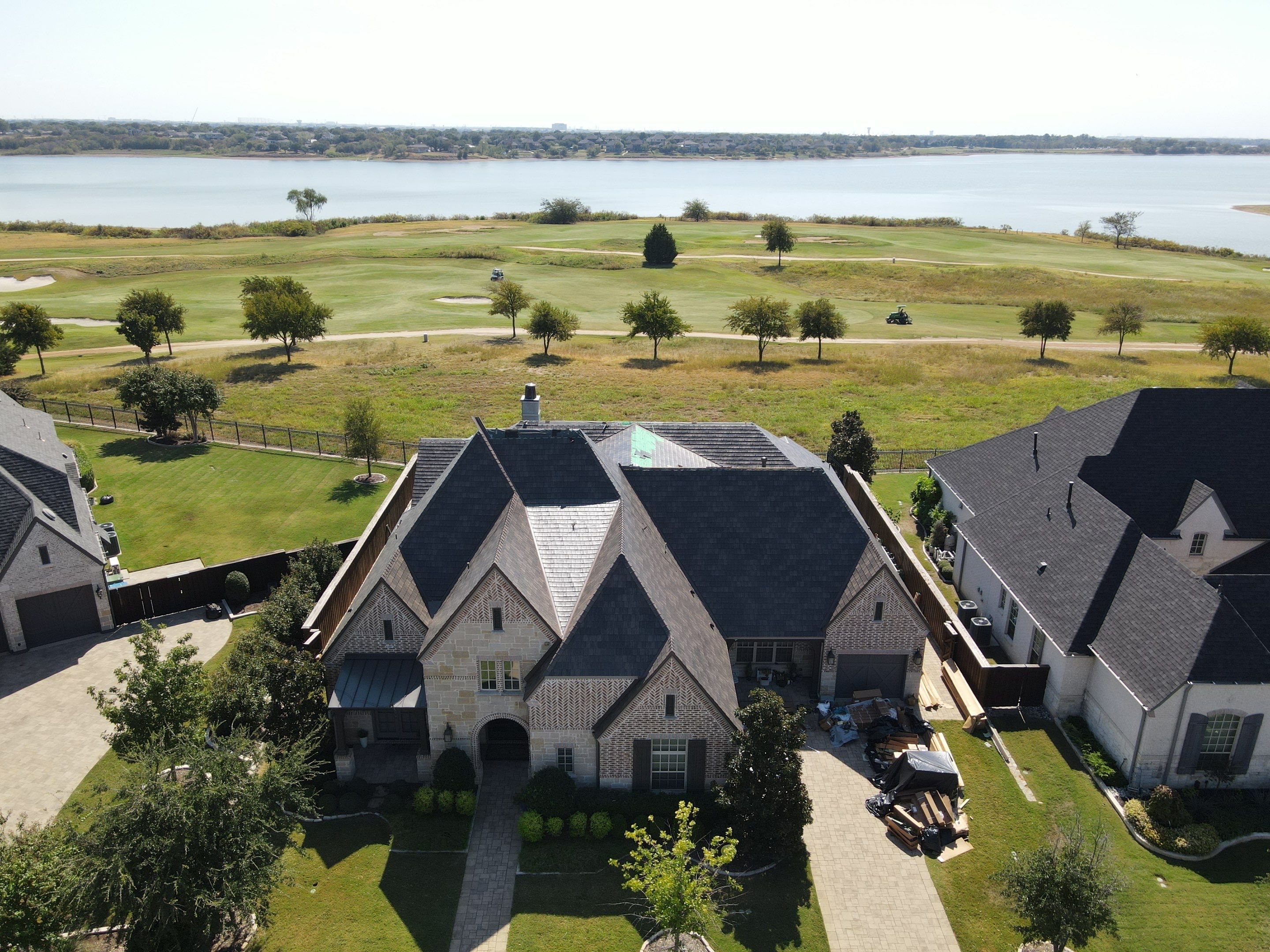 Luxury home with premium metal roof installation in North Texas overlooking lake