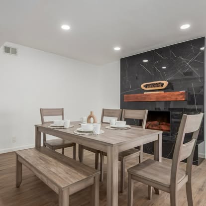 Modern Dining Area with Marble Fireplace - Kitchen & Dining Remodeling by Builders For You Construction in Yuma, AZ