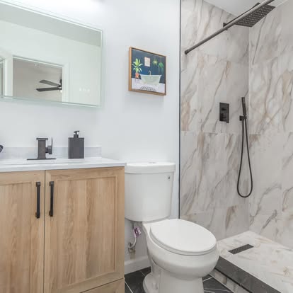 Marble-Look Shower with Wood Vanity Marble-Look Shower with Wood Vanity - Bathroom Remodeling by Builders For You Construction in Yuma, AZ
