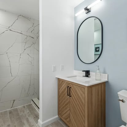 Marble-Look Shower & Wood Vanity Marble-Look Shower & Wood Vanity - Bathroom Remodeling by Builders For You Construction in Yuma, AZ