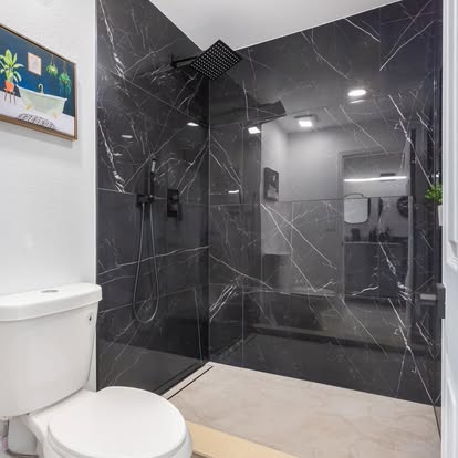 Sleek Black Marble-Look Shower Sleek Black Marble-Look Shower - Bathroom Remodeling by Builders For You Construction in Yuma, AZ