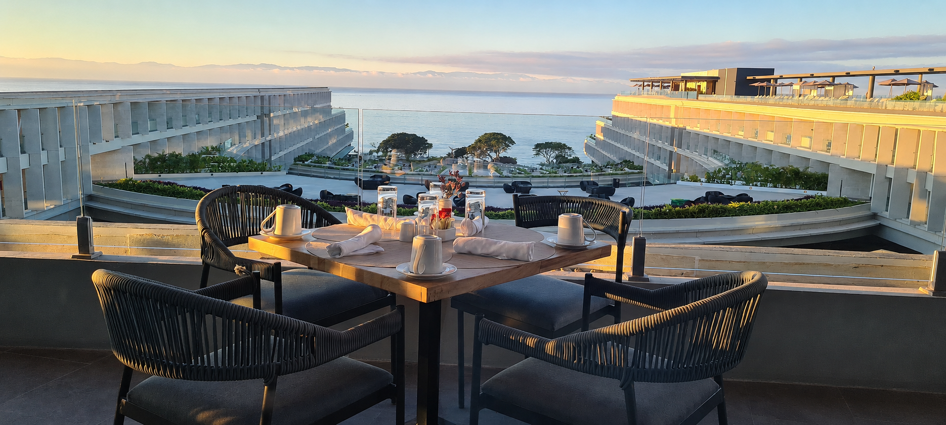 Breakfast table with ocean view representing travel business lifestyle benefits