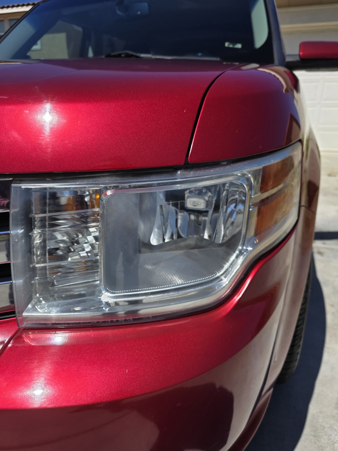 Clear restored Ford Flex headlight after professional restoration by LUMA Auto Studio in Riverside, CA