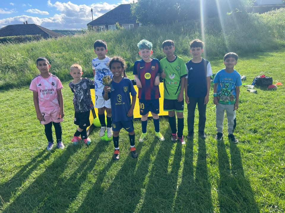 Young football players at an outdoor Aspire Elite Football Academy session