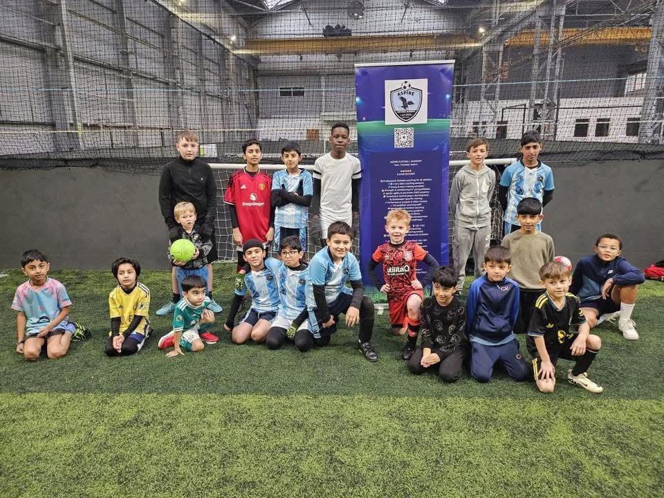 Aspire Elite Football Academy group photo at an indoor football session