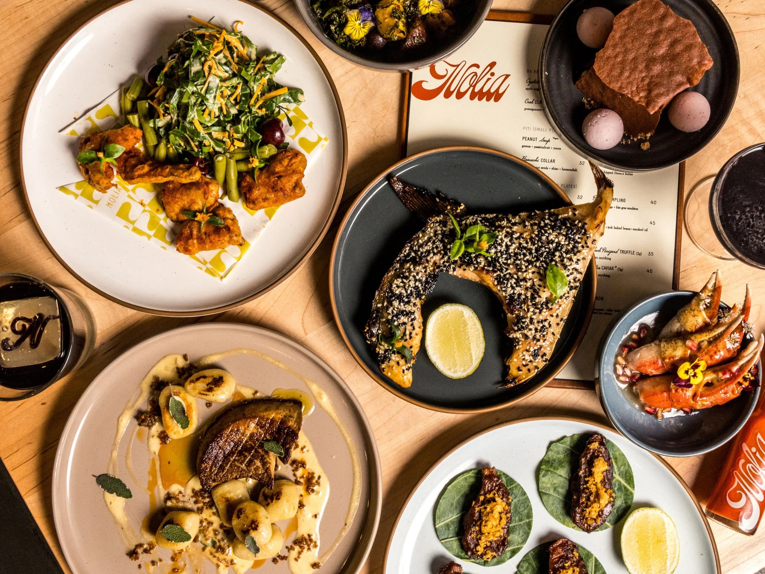 A colorful overhead spread of Southern-inspired dishes served at Nolia Kitchen in Over-the-Rhine, Cincinnati.