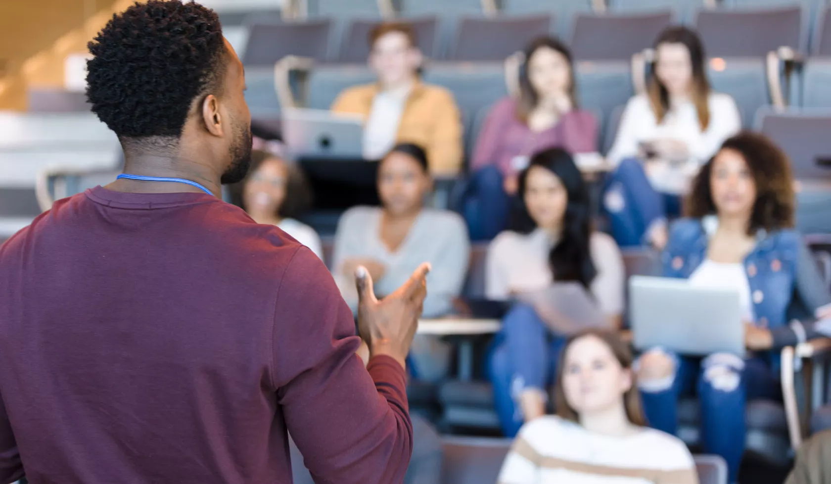 Educator presenting to peers in lecture hall