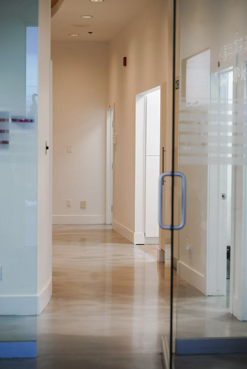 Modern clinic hallway with glass doors