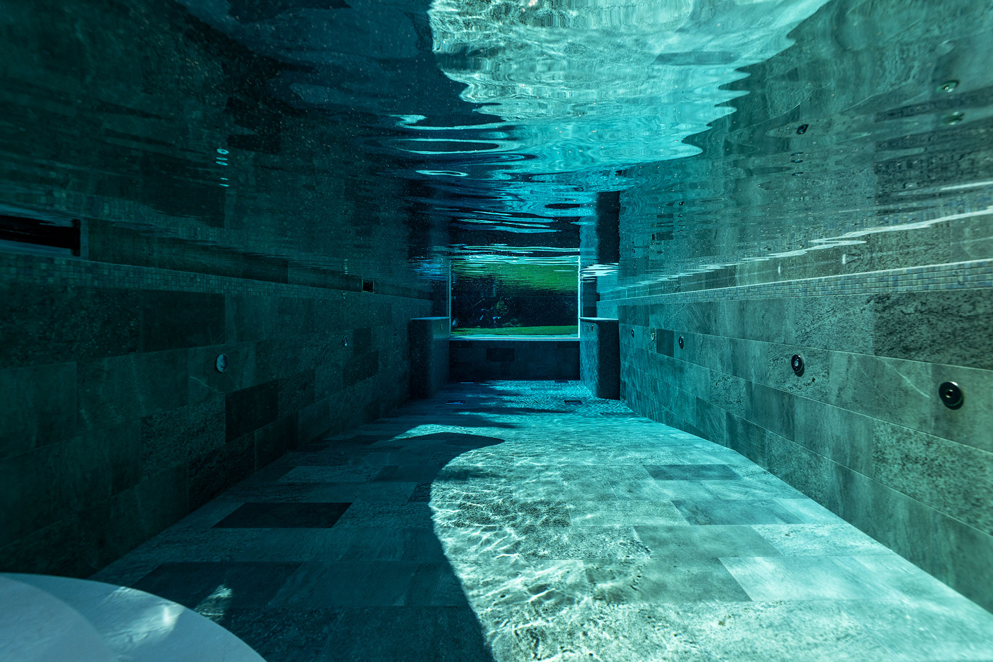 Underwater acrylic viewing window in a custom swimming pool by Poolcourt