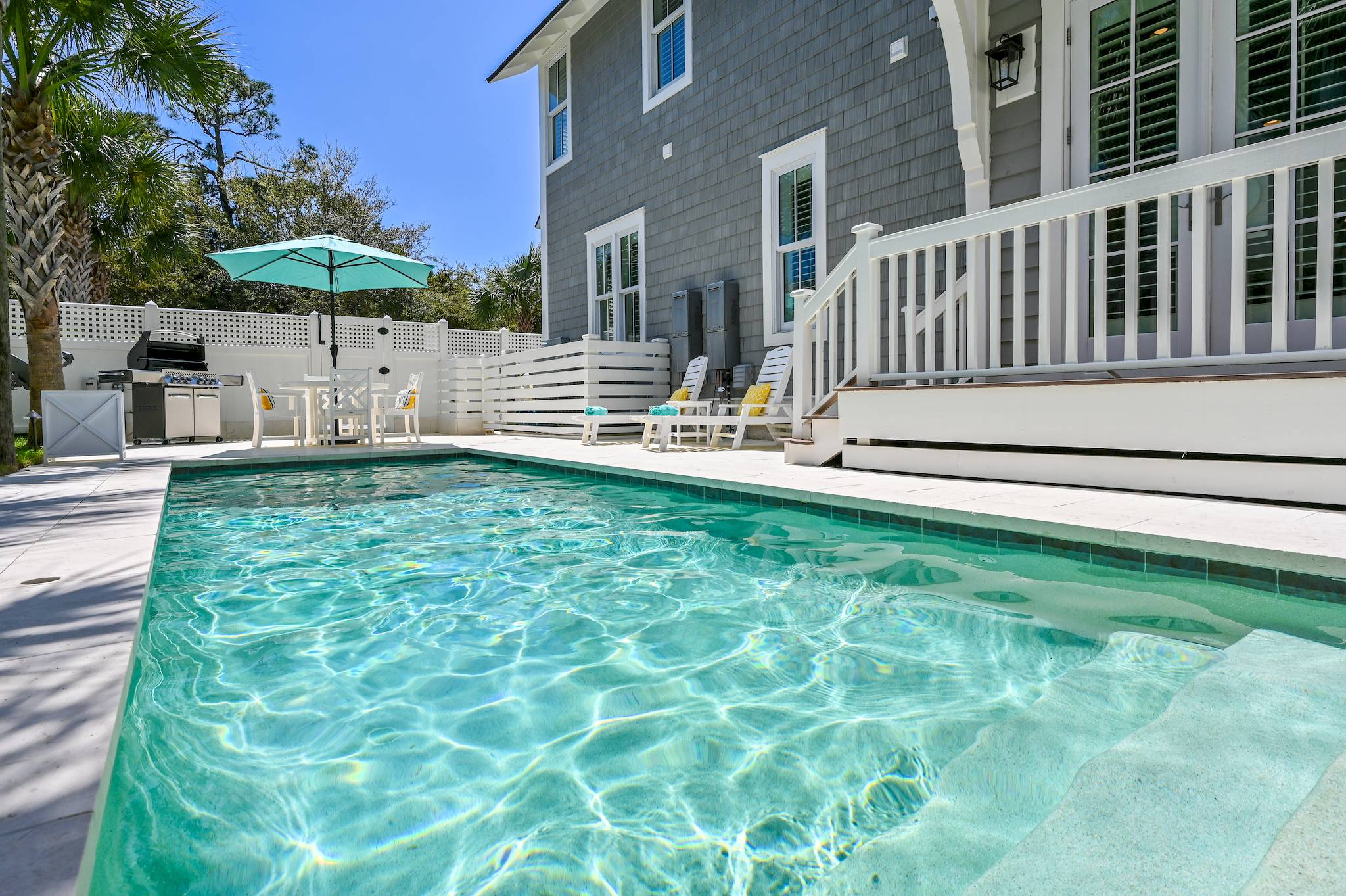 Pool cleaning service in Panama City Beach technician brushing steps