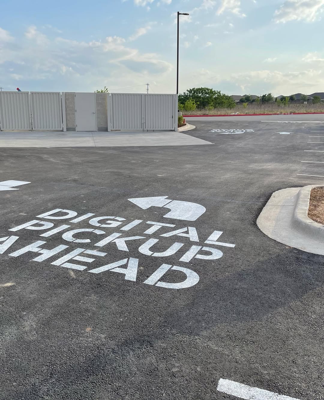Freshly striped parking stalls with crisp white lines by AWB Enterprise in Central Texas