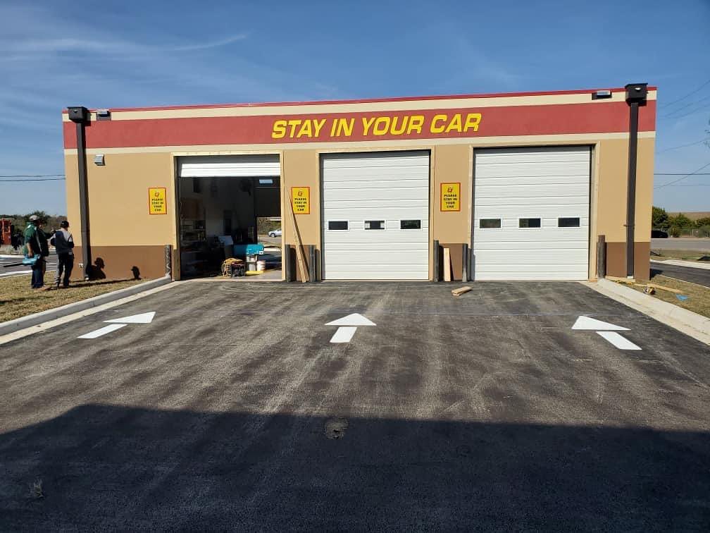 Directional 'Stay In Your Car' arrows and pavement markings painted by AWB Enterprise in Central Texas