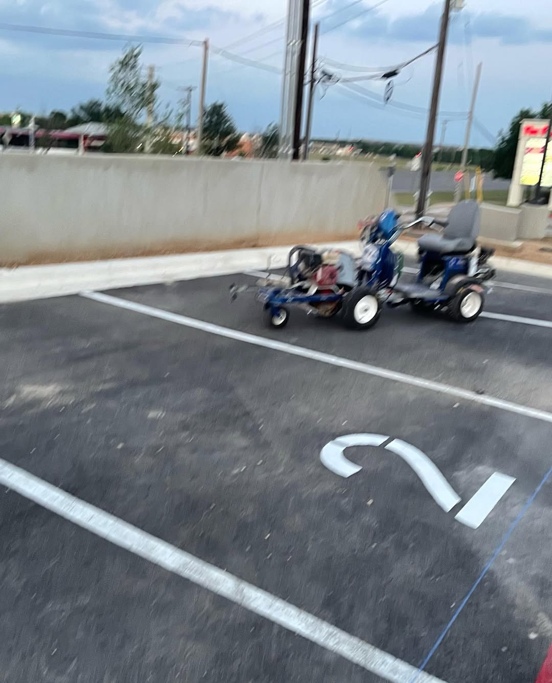 AWB Enterprise striping machine laying fresh traffic paint on a commercial parking lot in Austin, TX