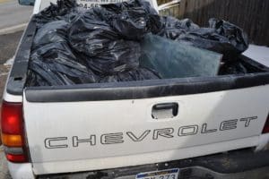 Truck bed full of garbage bags