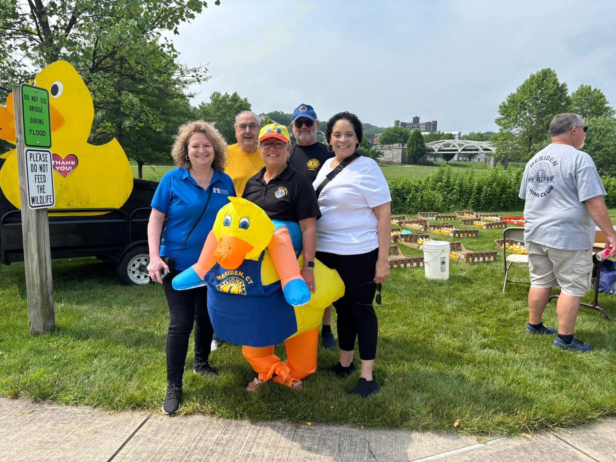 Daisy Olivo with Meriden Lions Club volunteers at the annual community duck race fundraiser event