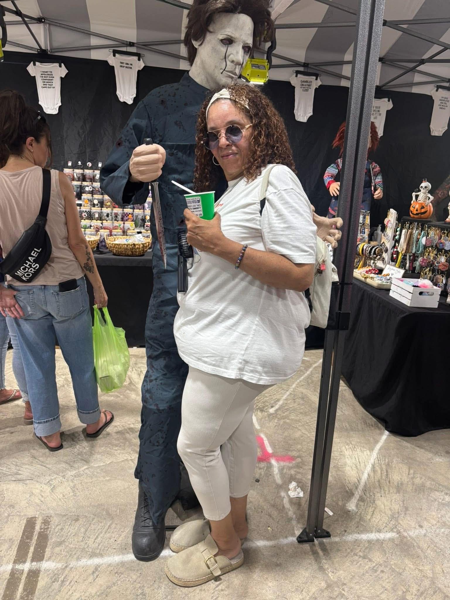 Daisy Olivo participating cheerfully at a local community Halloween fair and market event