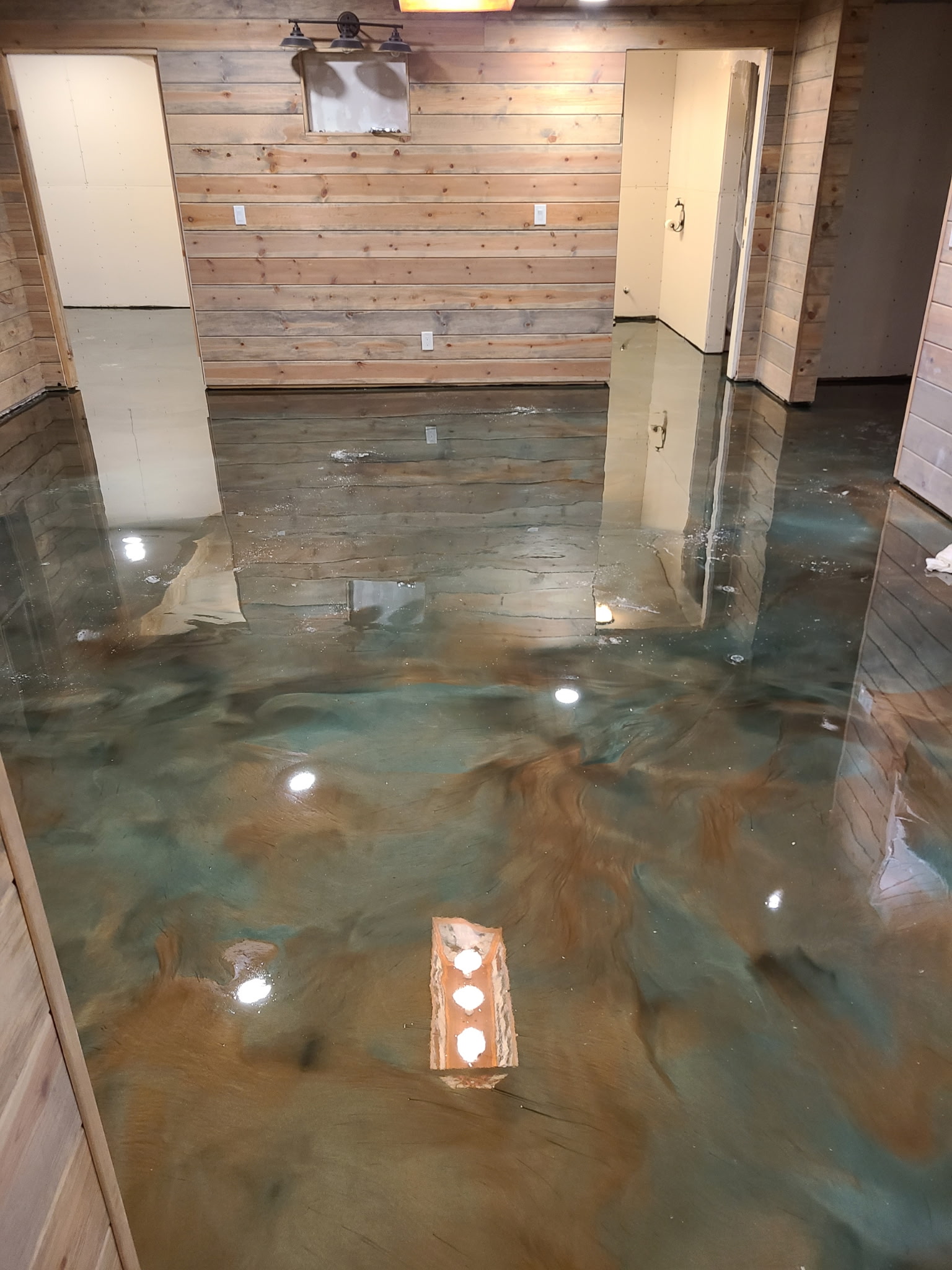 Finished basement with metallic epoxy floor