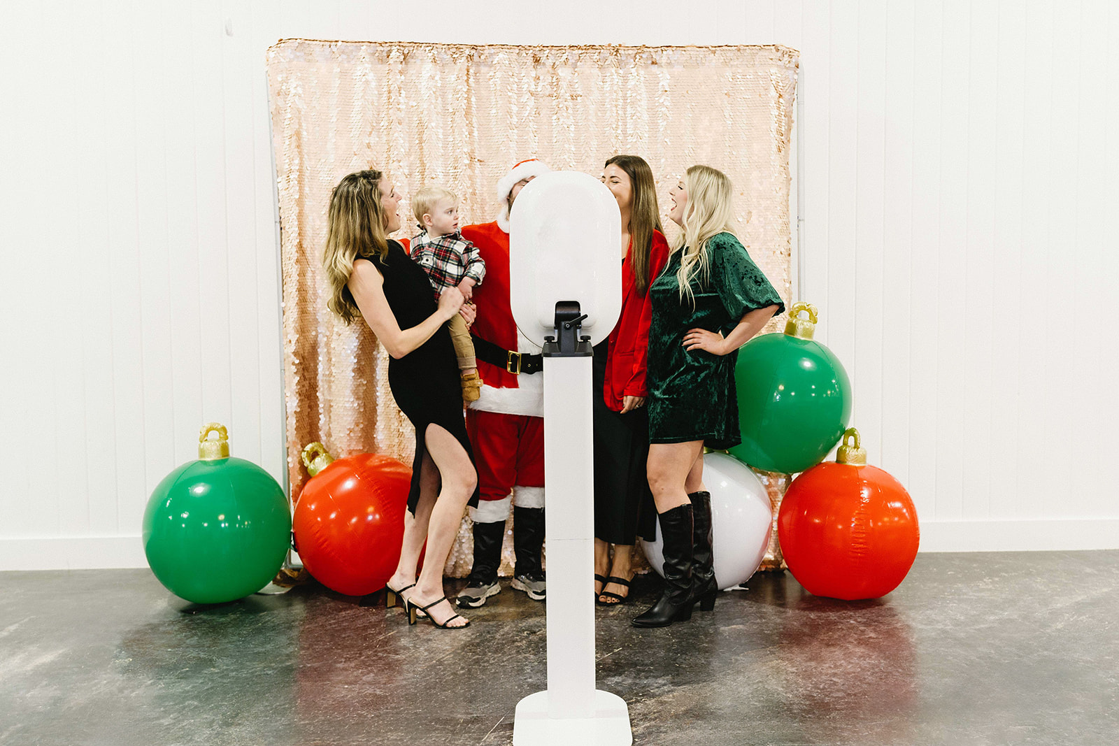 Full sleek modern photo booth setup with holiday backdrop