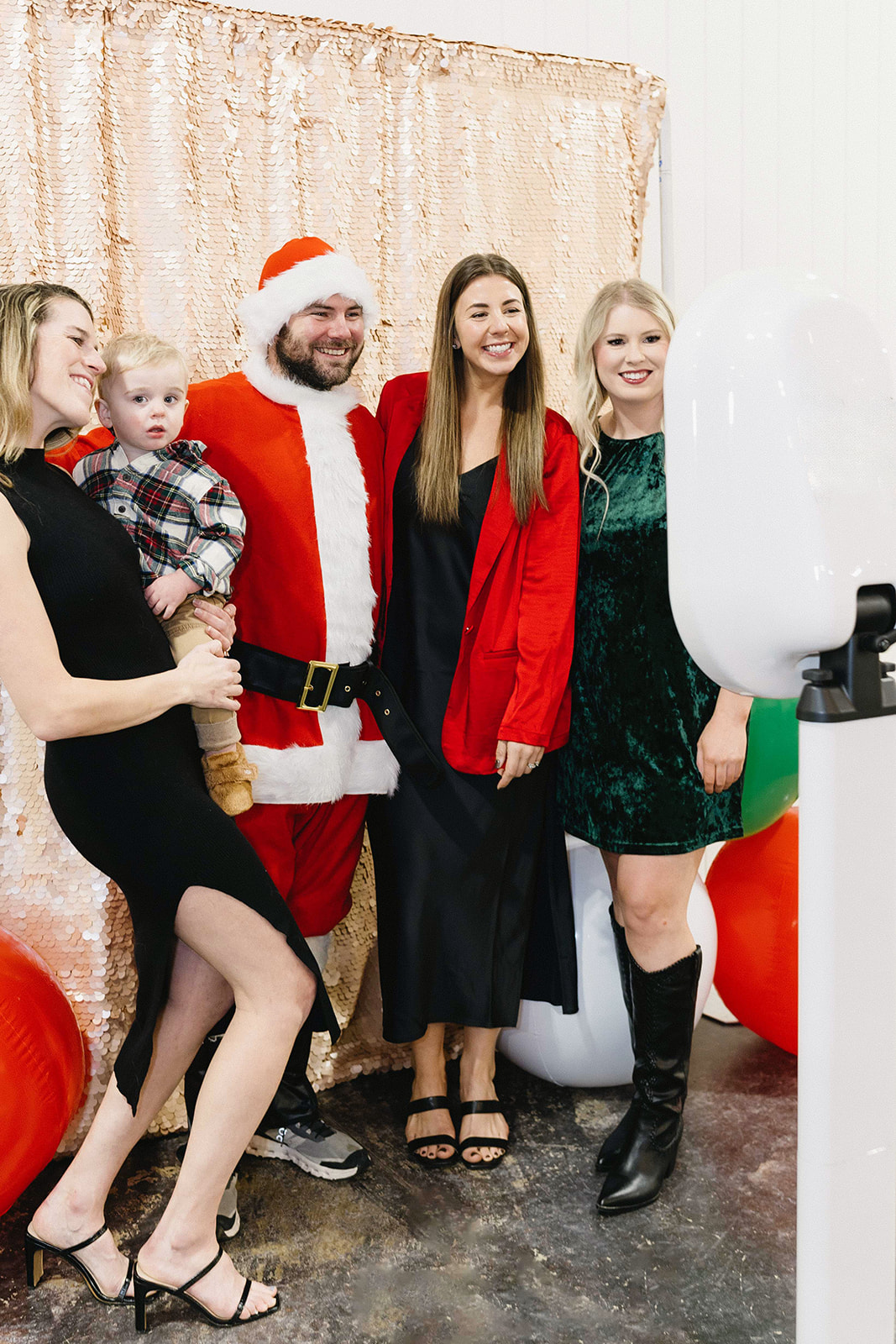 Santa and guests posing at Photo Love photo booth station