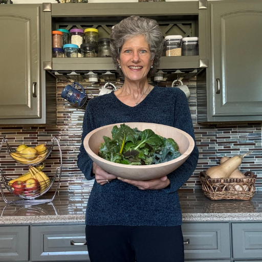 Karen Schriefer holding fresh greens from her Tower Garden