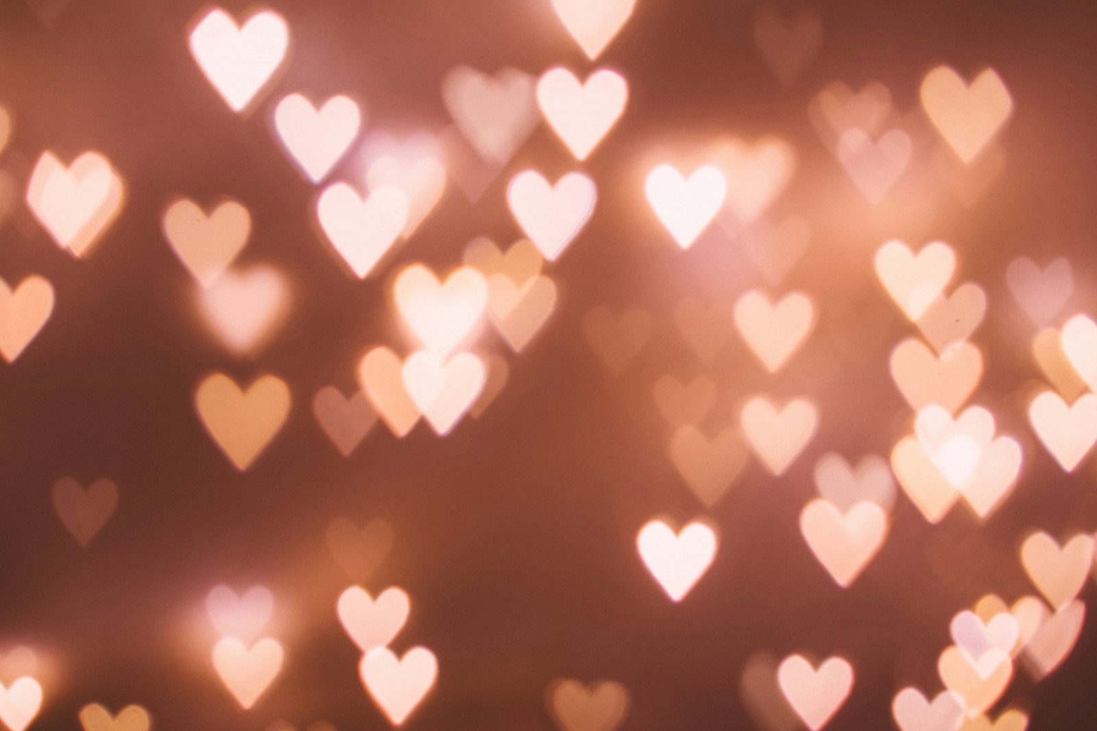 Heart-shaped bokeh light patterns in warm tones