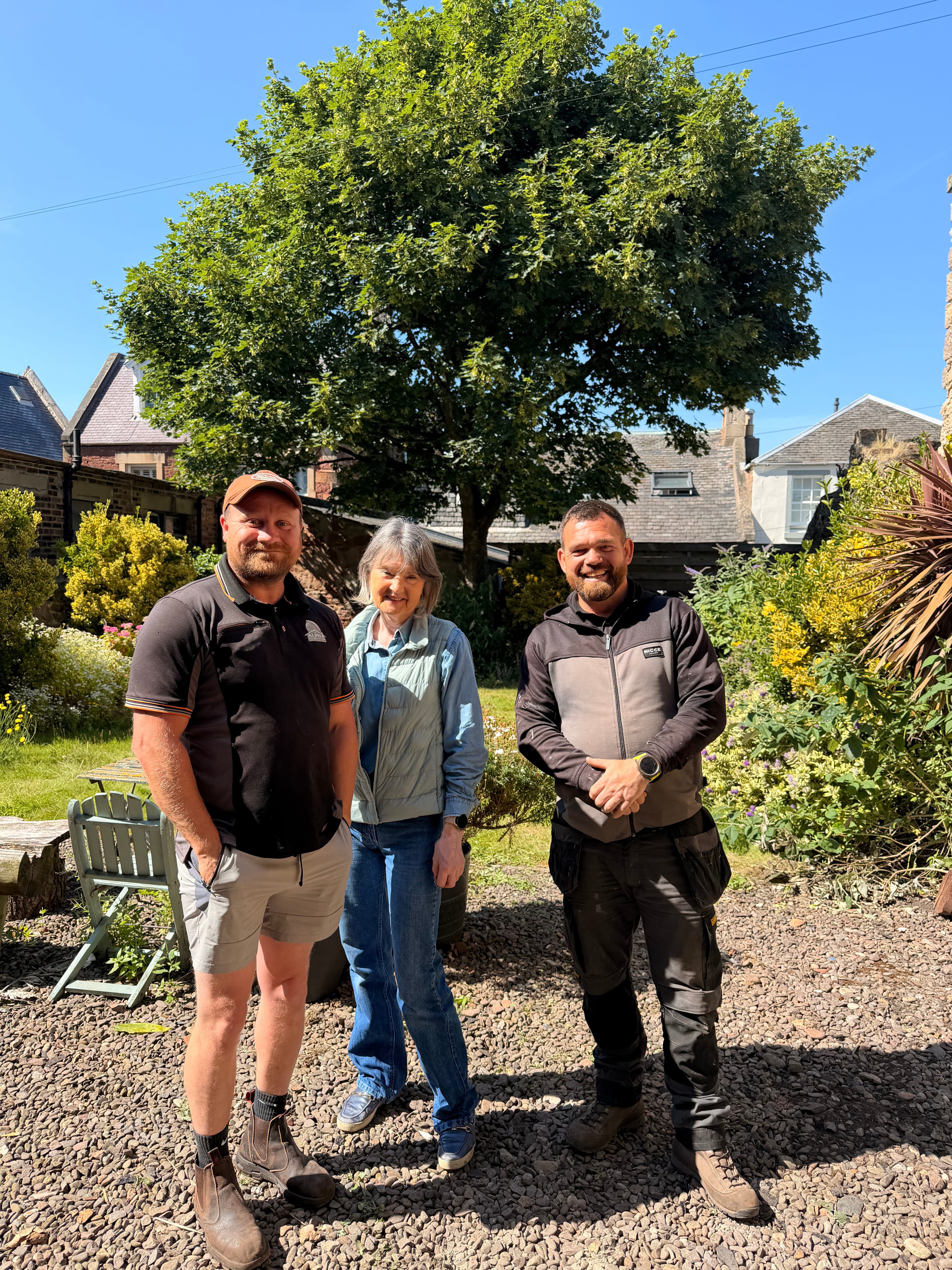 Alpha Roofing owners with a happy customer in North Berwick
