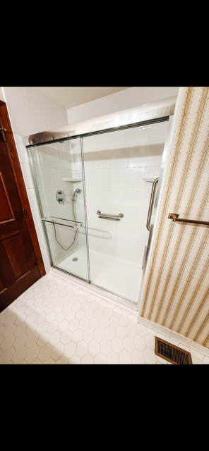 Finished Sliding-Glass Shower Installation with White Surround & Hexagonal Flooring