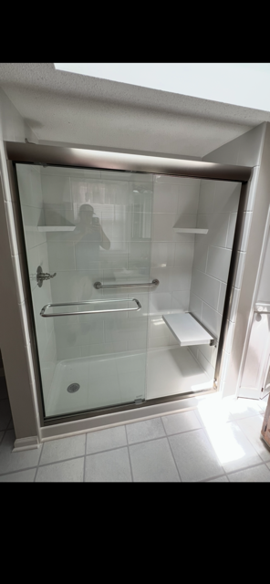 White Tile Shower with Stainless Frame, Grab Bars & Built-in Seating