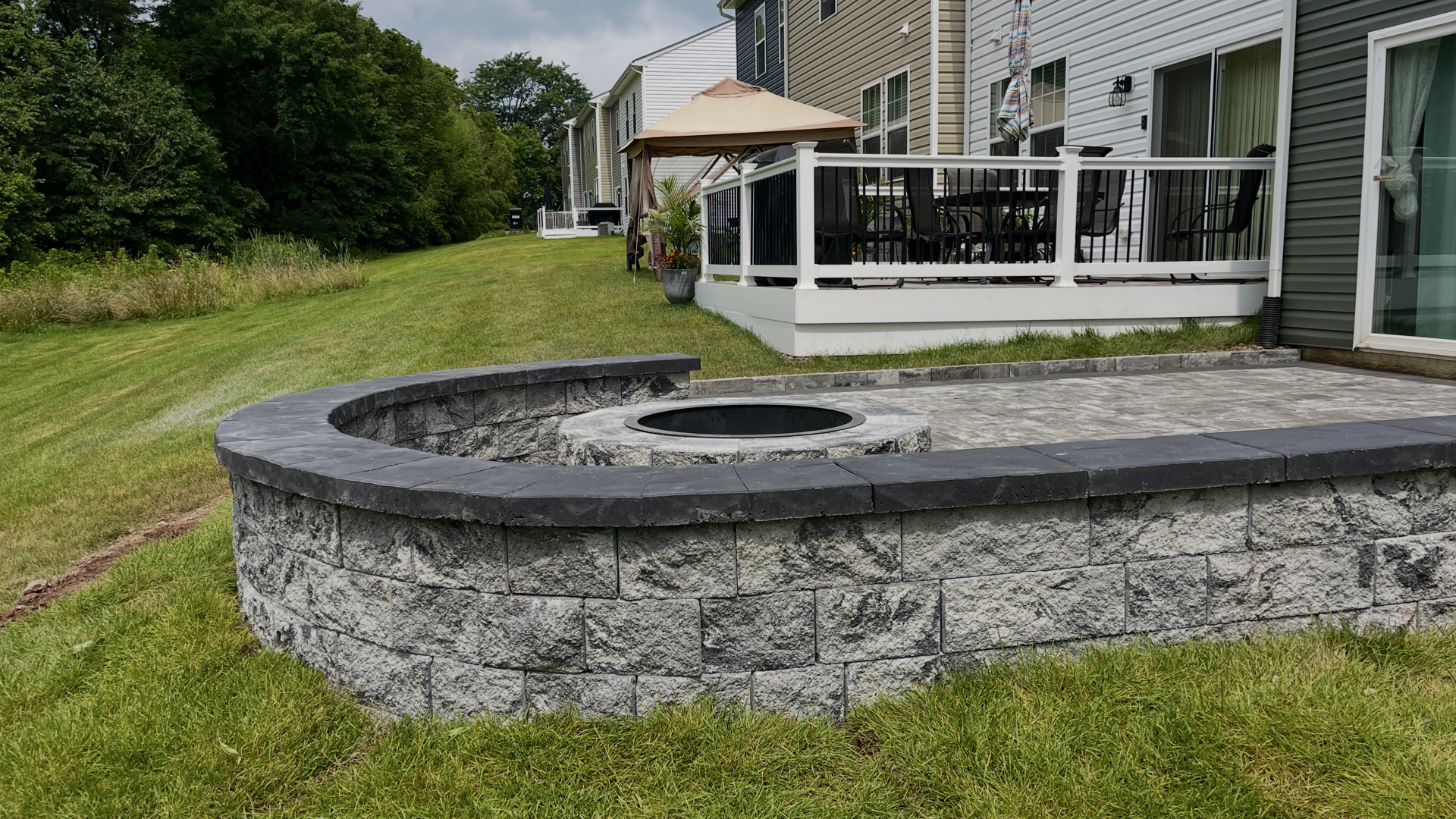 Raised Stone Patio with Integrated Fire Pit Wall